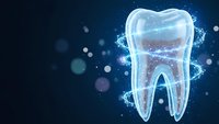 Glowing digital tooth hologram with sparkling particles on dark blue background for dental care and oral health technology concepts.