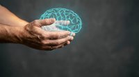 Male hands cupping glowing blue brain hologram representing mental health protection, neuroscience research, cognitive care and psychological wellness concepts.