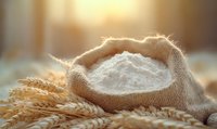 White flour in burlap sack surrounded by golden wheat ears on wooden surface with warm sunlight, fresh organic baking ingredients for homemade bread and pastries.