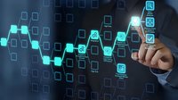 Businessman touching digital interface with glowing hexagonal network icons and data visualization elements on dark blue technology background.