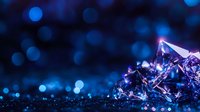Glowing crystal formations against dark background with blue bokeh lights create magical atmosphere. Macro photography reveals intricate mineral structure.