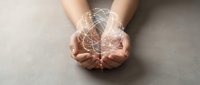 Young adult hands cupped together holding glowing digital network lines and particles, representing connection, technology, data transfer, and innovation for business and communication concepts.