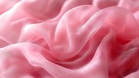 Soft pink silk fabric with elegant waves and folds creating gentle curves and shadows, showcasing luxurious textile texture for fashion and interior design backgrounds.