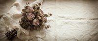 Vintage sepia-toned dried flower bouquet with burlap ribbon on white linen fabric, rustic wedding decor and romantic shabby chic style arrangement.