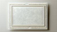 Elegant white decorative frame with beaded border detail on light wall background, isolated design element for artwork and photography presentation.