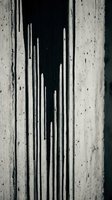 Black paint dripping down a rough concrete wall, creating dramatic streaks and abstract texture in monochrome tones for art and design.