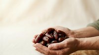 Close-up of hands holding fresh dates, ideal for food, nutrition, healthy eating, and organic product marketing materials.