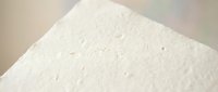 White textured paper surface with subtle grain and fiber details, suitable for backgrounds, design projects, packaging mockups, and print materials.
