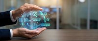 Business professional protecting digital data quality process with holographic technology icons floating between hands in modern office environment.