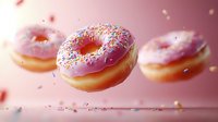 Flying pink glazed donuts with colorful sprinkles floating in air against soft pink background, dynamic food composition with falling sprinkles and bokeh effect.