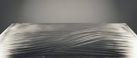 Large stack of white paper sheets with curved edges creating flowing lines against neutral background for office and business concepts.