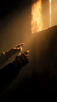 Hands reaching toward dramatic golden light beam in dark atmospheric setting with warm glow and mysterious ambiance for spiritual and inspirational concepts.