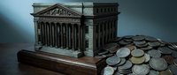 Classical government building model with scattered coins representing financial institutions, banking system, treasury operations, and economic policy concepts.