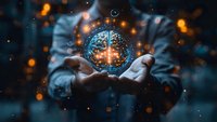 Futuristic holographic brain projection floating above open hands, surrounded by glowing particles and digital elements in dark blue and orange tones, perfect for artificial intelligence concepts.