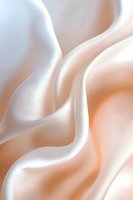 Soft flowing curves in peach and white create an elegant abstract background with smooth silky texture and gentle gradients for luxury branding and design projects.
