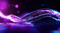 Glowing purple and blue light waves with sparkling particles create magical atmosphere against dark background, abstract luminous motion effect.