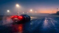 Sports car driving on wet asphalt road at night with glowing street lights and atmospheric fog creating dramatic urban scene for automotive advertising.