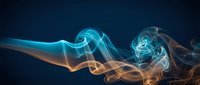 Abstract flowing smoke waves in blue and orange colors creating dynamic energy patterns against dark background for modern digital art projects.