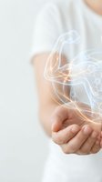 Person in white shirt holding cupped hands with glowing digital light effects and flowing energy streams for technology and innovation concepts.