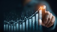 Businessman touching digital hologram showing growing financial chart and statistics data analysis. Business growth concept with glowing effect.