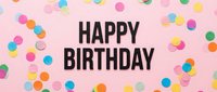 Happy birthday text on pink background surrounded by colorful confetti circles, festive celebration concept for greeting cards and party designs.