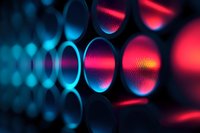Abstract macro photography of metallic mesh or grid structure with neon pink and blue gradient lighting creating futuristic technological pattern with circular bokeh effect.