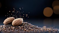 Whole almonds on dark ground with golden bokeh lights and scattered poppy seeds creating magical food composition with copy space for text.