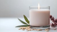 Glowing pink scented candle in glass holder with oat flakes and green leaves on light background, creating peaceful spa atmosphere for wellness and relaxation.