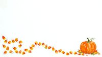 Candy corn and pumpkin isolated on white background, ready for autumn designs, greeting cards, and seasonal marketing materials.