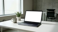 Modern laptop with blank white screen on clean office desk workspace for business presentations and mockup designs.