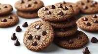 Fresh baked chocolate chip cookies arranged in stack with scattered chocolate morsels on white background, selective focus on crispy golden edges.