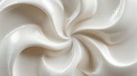 Creamy white swirling texture with smooth flowing curves creating an elegant spiral pattern. Ideal for food packaging, cosmetic backgrounds, or abstract design elements.