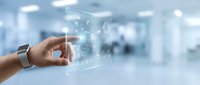 Businessperson hand touching digital interface with financial icons and data visualization in modern office environment for technology and business solutions.