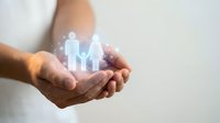 Hands holding glowing family icons representing protection, care and insurance coverage for loved ones in modern digital healthcare concept.