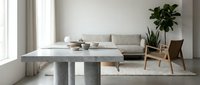Modern minimalist living room with concrete coffee table, beige sofa, wooden chair and fiddle leaf fig plant in neutral tones for contemporary home decor.