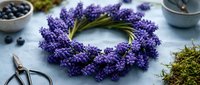 Fresh lavender wreath with purple flowers on rustic table with blueberries and moss for aromatherapy spa decoration and natural home decor crafting.