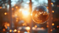 Sparkling disco ball reflects golden lights creating magical atmosphere for party celebration and nightlife entertainment events.