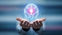 Businessman hands holding glowing digital brain with pink core and light particles representing artificial intelligence, innovation and future technology concepts.