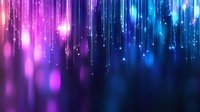 Magical glowing particles falling like rain against dark background with gradient from pink to blue colors creating dreamy atmospheric effect.