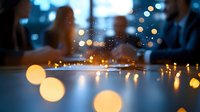 Blurred bokeh lights creating warm golden glow on wet surface with water droplets, abstract background for modern design projects and presentations.