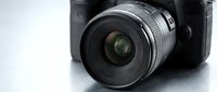 Professional camera lens with wide aperture mounted on DSLR body, isolated on white background. Suitable for photography, technology, and equipment design projects.