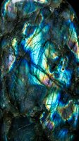 Stunning labradorite mineral specimen displaying vibrant blue and green iridescent flashes with natural crystalline structure and metallic luster for geology concepts.