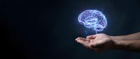 Glowing digital brain hologram floating above open palm against dark background representing artificial intelligence, neuroscience and mental health concepts.