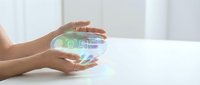 Hands holding glowing holographic sphere with digital interface icons and data visualization for technology, innovation, and business solutions.