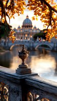 Autumn sunset view of St Peters Basilica dome framed by golden leaves, ornate stone railing detail in foreground, reflecting in Tiber river with historic bridge.