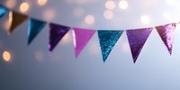 Festive glittery bunting banner with blue, purple and pink triangular flags against blurred bokeh lights background creates celebratory party atmosphere.