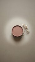 Minimalist pink ceramic bowl with dried white flowers on neutral beige background for modern home decor and lifestyle photography.
