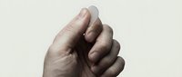Closeup of adult male hands with fair skin tone clasped together in gesture of unity, prayer, or agreement against neutral background for business and wellness concepts.