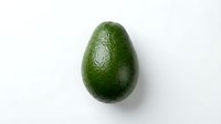 Ripe avocado with textured green skin isolated on white background, ready for food and nutrition design projects, cooking websites, and healthy eating content.