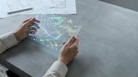 Hands of a professional woman in business attire interacting with a holographic digital map display showing network connections and data visualization on a modern workspace desk.